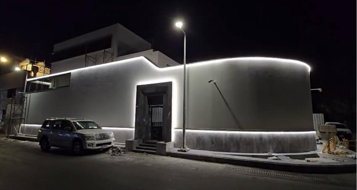The exterior enclosure and entrance after dark.