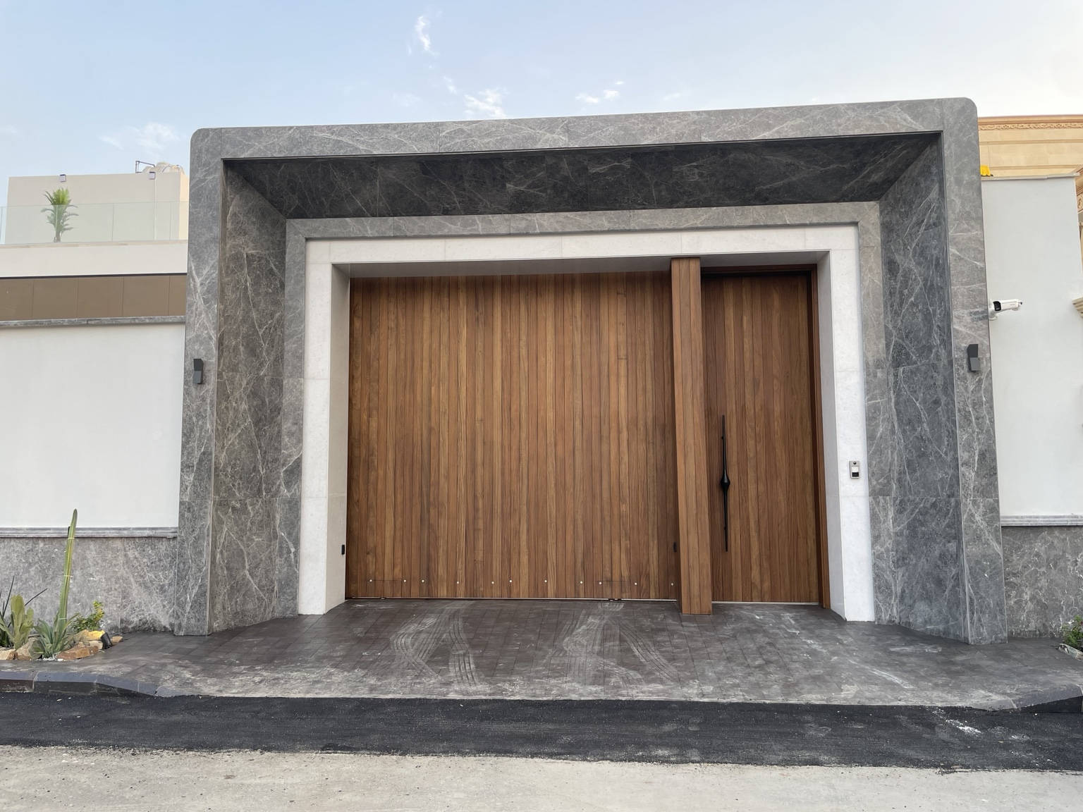 The completed entrance — timber within a layered stone frame.